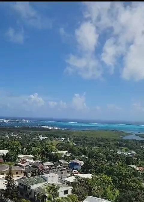 Rooftops of San Andrés seen from the hill at La Loma under a big blue sky.