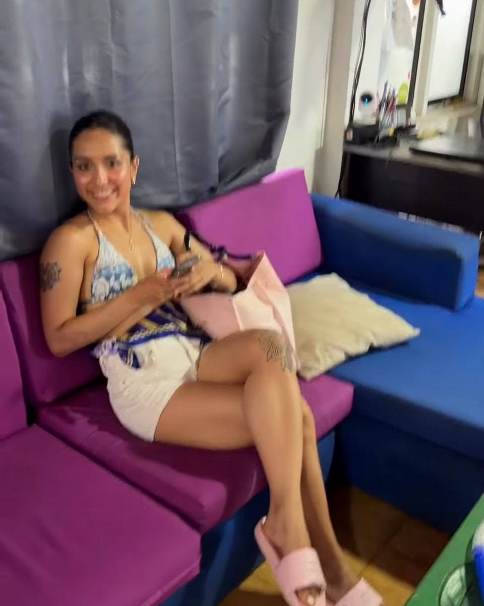A guest relaxing on the purple and cobalt-blue sofa in the lounge.